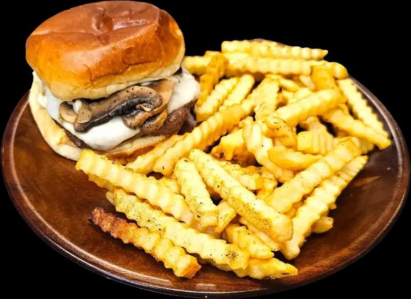Mushroom Swiss burger with crinkle-cut fries on a wooden plate at D'sign Pizza
